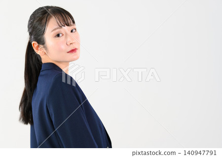 A businesswoman strikes a pose looking back. 140947791