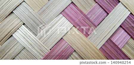 Traditional woven bamboo texture with a natural cream and pink color pattern. Traditional woven bamboo texture with a natural cream and pink color pattern. 140948254