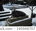 A statue of a cow in the snow 140948707