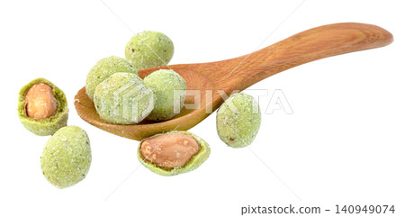Wasabi coated peanuts in a wooden spoon and scattered. Spicy green snack with crunchy coating showing whole and halved nuts. Healthy legumes for appetizer or party food. 140949074
