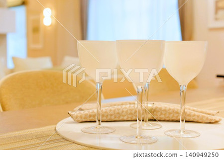 An elegant table setting with rows of wine glasses. 140949250