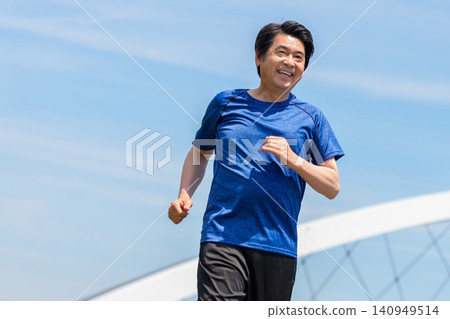 Senior men jogging under a blue sky Senior men jogging under a blue sky 140949514