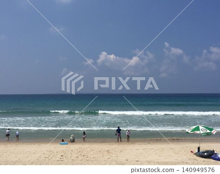 A liberating summer beach scene with white sand and a blue sea stretching out before you. A liberating summer beach scene with white sand and a blue sea stretching out before you. 140949576