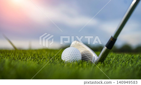 Golf clubs and balls on a green lawn in a beautiful golf course with morning sunshine. Golf clubs and balls on a green lawn in a beautiful golf course with morning sunshine. 140949583