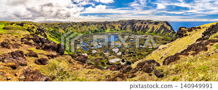 A beautiful panoramic view of the Rano Kau volcano crater lake under a blue sky on Easter Island, Chile A beautiful panoramic view of the Rano Kau volcano crater lake under a blue sky on Easter Island, Chile 140949991