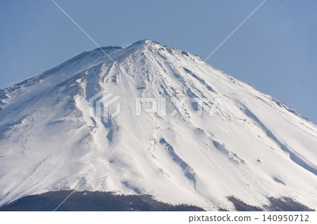 The summit of Mount Fuji rises above the steep northern face of Mount Fuji, where numerous deeply carved ravines flow, and Mount Hakusan, the second highest peak, is located in the center. The summit of Mount Fuji rises above the steep northern face of Mount Fuji, where numerous deeply carved ravines flow, and Mount Hakusan, the second highest peak, is located in the center. 140950712