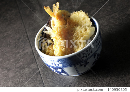A piping hot tempura rice bowl containing shrimp, whiting, eggplant, and sweet potato. A piping hot tempura rice bowl containing shrimp, whiting, eggplant, and sweet potato. 140950805