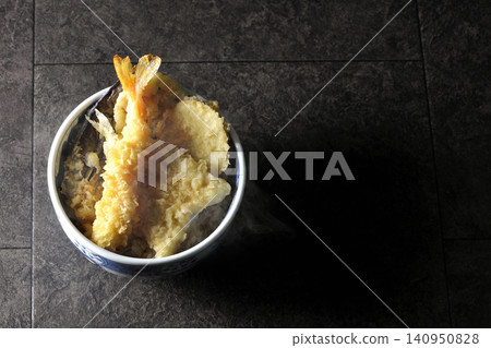 A piping hot tempura rice bowl containing shrimp, whiting, eggplant, and sweet potato. A piping hot tempura rice bowl containing shrimp, whiting, eggplant, and sweet potato. 140950828