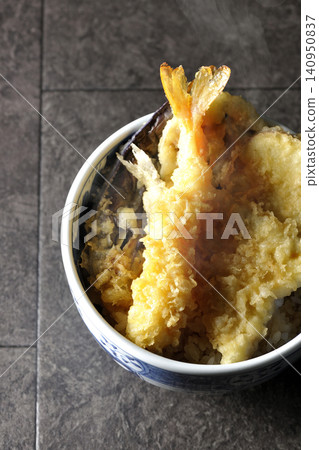 A piping hot tempura rice bowl containing shrimp, whiting, eggplant, and sweet potato. 140950837