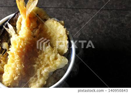 A piping hot tempura rice bowl containing shrimp, whiting, eggplant, and sweet potato. A piping hot tempura rice bowl containing shrimp, whiting, eggplant, and sweet potato. 140950843