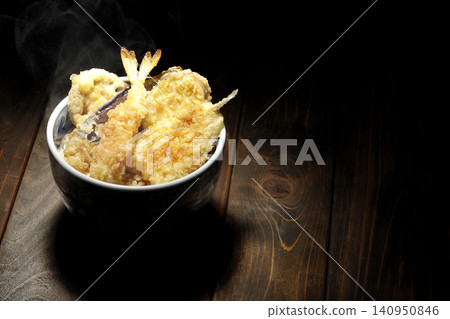 A piping hot tempura rice bowl containing shrimp, whiting, eggplant, and sweet potato. A piping hot tempura rice bowl containing shrimp, whiting, eggplant, and sweet potato. 140950846