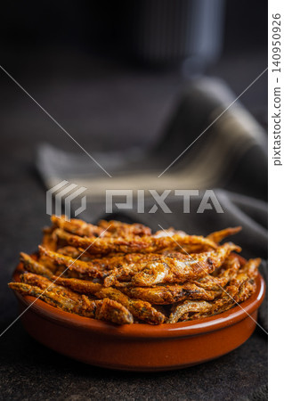 Crispy Fried smelts in Bowl . Golden Small Fish Snack and Seafood Appetizer Crispy Fried smelts in Bowl . Golden Small Fish Snack and Seafood Appetizer 140950926