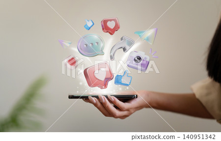 Cropped hand holding smartphone with floating 3D social media icons for digital marketing and online communication 140951342