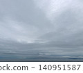 A sky full of clouds and a calm horizon 140951587