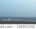 A beach with calm summer waters and a lifeguard observation post. 140951592