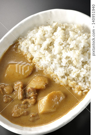 Barley rice and Massaman curry photographed individually against a black background. 140951940