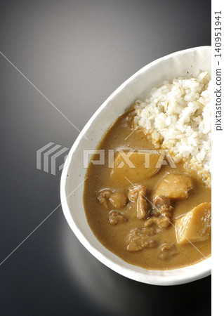 Barley rice and Massaman curry photographed individually against a black background. Barley rice and Massaman curry photographed individually against a black background. 140951941