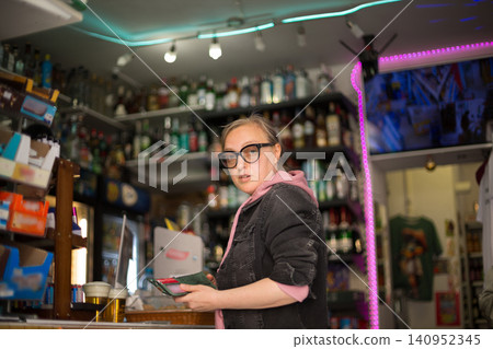 Female customer holding wallet while shopping Female customer holding wallet while shopping 140952345