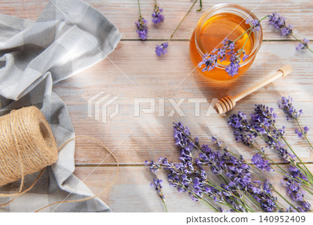 Honey jar with fresh lavender flowers and rustic elements Honey jar with fresh lavender flowers and rustic elements 140952409
