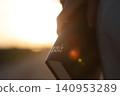 A Christian holding the holy Bible, the word of truth; background of faith, belief, worship, and prayer. 140953289