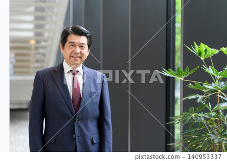 Asian businessman standing with a smile Asian businessman standing with a smile 140953337
