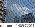 Clouds reflected in the windows of an office building 140953504