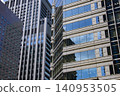Clouds reflected in the windows of an office building 140953505