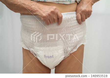 Asian senior woman patient wearing adult incontinence diaper pad in hospital. Asian senior woman patient wearing adult incontinence diaper pad in hospital. 140953519