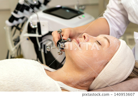 Microcurrent Facial Therapy on Chin and Jawline in Beauty Clinic Microcurrent Facial Therapy on Chin and Jawline in Beauty Clinic 140953607