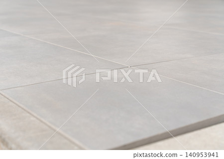Durable 80x80 cm outdoor floor tiles with a concrete optic finish, ideal for streets, sidewalks, patios, and urban landscaping. High quality photo Durable 80x80 cm outdoor floor tiles with a concrete optic finish, ideal for streets, sidewalks, patios, and urban landscaping. High quality photo 140953941