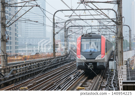 A Shanghai Metro train leaving Baoshan Road Station in the rain. 140954225
