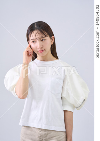 Japanese woman holding her head Japanese woman holding her head 140954302