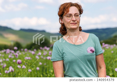 Authentic mature woman enjoying nature in a flowering countryside landscape 140954379