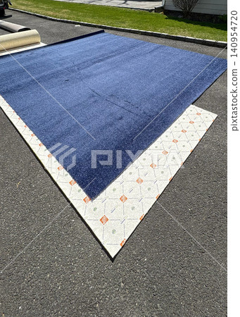 New Carpet Installation Process on a Sunny Day in the Yard New Carpet Installation Process on a Sunny Day in the Yard 140954720