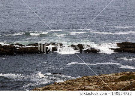 Ocean water rolling over barrier rocks off the coast of Galicia Spain Ocean water rolling over barrier rocks off the coast of Galicia Spain 140954723