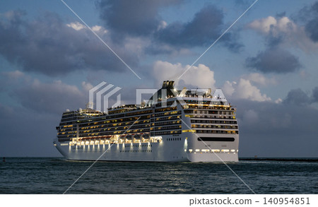 Cruise ship vacation. Bon voyage. Majestic cruise ship in vacation summer. Cruise ship vacation and travel at sea. View of illuminated luxury liner. Ship at night port. Luxury sea vacation Cruise ship vacation. Bon voyage. Majestic cruise ship in vacation summer. Cruise ship vacation and travel at sea. View of illuminated luxury liner. Ship at night port. Luxury sea vacation 140954851