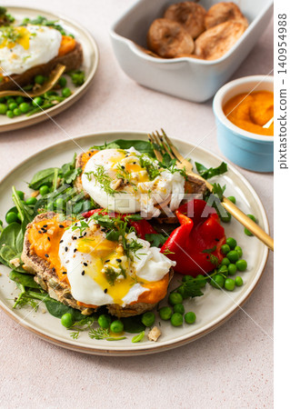 This meal features gluten free bread sandwiches topped with zucchini caviar and poached egg. It includes roasted red peppers and green peas, served with baked pears This meal features gluten free bread sandwiches topped with zucchini caviar and poached egg. It includes roasted red peppers and green peas, served with baked pears 140954988