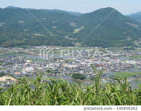 View of a rural town nestled in the mountains View of a rural town nestled in the mountains 140956262