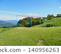 A swing on a hill and a townscape in a valley 140956263