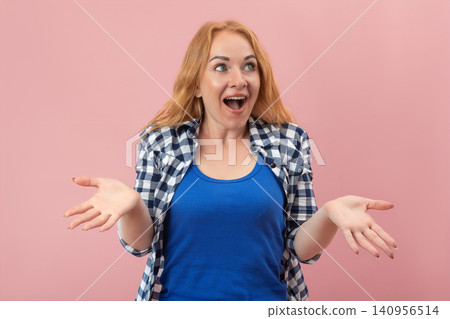 Young woman with red hair expressing extreme surprise and amazement, her mouth wide open and hands gesturing in disbelief on a pink background Young woman with red hair expressing extreme surprise and amazement, her mouth wide open and hands gesturing in disbelief on a pink background 140956514