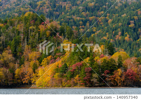 Autumn scenery of Lake Shikaribetsu and the forest ablaze with autumn colors, as seen from the hiking trail on Mt. Shirakumo near Lake Shikaribetsu in Hokkaido. (Tourist attraction) Autumn scenery of Lake Shikaribetsu and the forest ablaze with autumn colors, as seen from the hiking trail on Mt. Shirakumo near Lake Shikaribetsu in Hokkaido. (Tourist attraction) 140957340