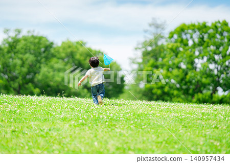 A 2-year-old boy catching insects in the summer A 2-year-old boy catching insects in the summer 140957434