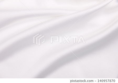 Smooth elegant white silk or satin luxury cloth texture as wedding background. Luxurious background design Smooth elegant white silk or satin luxury cloth texture as wedding background. Luxurious background design 140957870