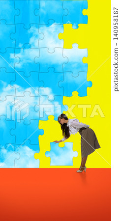 Woman placing final puzzle piece into giant sky pattern composition. Woman placing final puzzle piece into giant sky pattern composition. 140958187