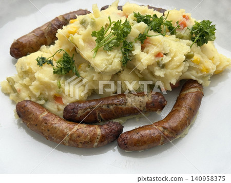 Traditional small grilled bratwurst sausages with mashed potatoes called rostbratwuerstchen Traditional small grilled bratwurst sausages with mashed potatoes called rostbratwuerstchen 140958375