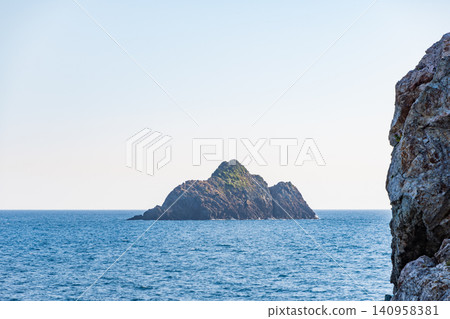 A remote island floating in the Pacific Ocean off the coast of Wakayama Prefecture and its rocky coastline. A remote island floating in the Pacific Ocean off the coast of Wakayama Prefecture and its rocky coastline. 140958381