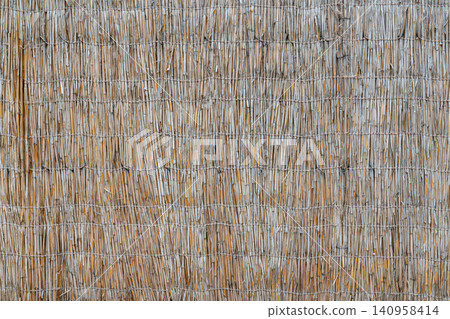 Building a wall with straw and twigs in rural area Building a wall with straw and twigs in rural area 140958414