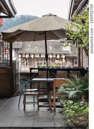 an outdoor patio or terrace dining area set against a backdrop of traditional architecture. an outdoor patio or terrace dining area set against a backdrop of traditional architecture. 140958709