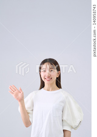 A Japanese woman is guiding with her arms outstretched. A Japanese woman is guiding with her arms outstretched. 140958743