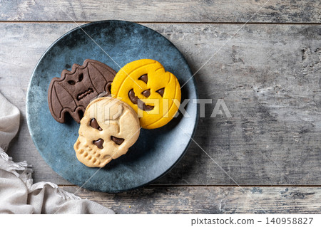 Halloween sandwich cookies on wooden table Halloween sandwich cookies on wooden table 140958827